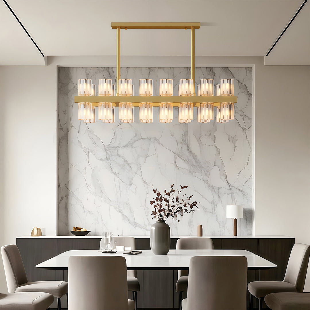 Luxury crystal chandeliers illuminating minimalist dining room with marble feature wall
