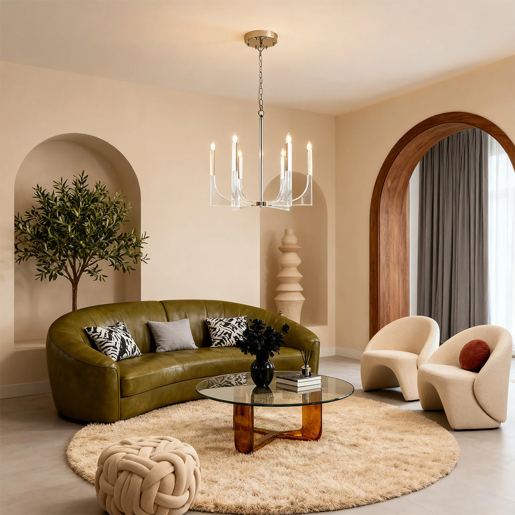 Mid-century retro chandeliers with chrome accents and curving arms, lighting a chic living room with a green leather sofa.