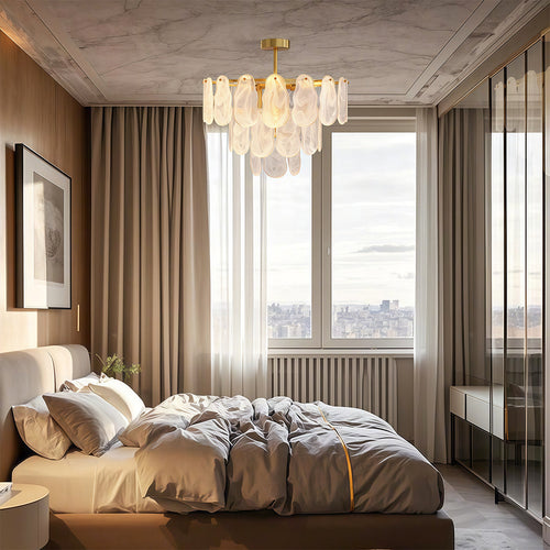Midcentury modern chandelier above circular dining table in warm contemporary interior