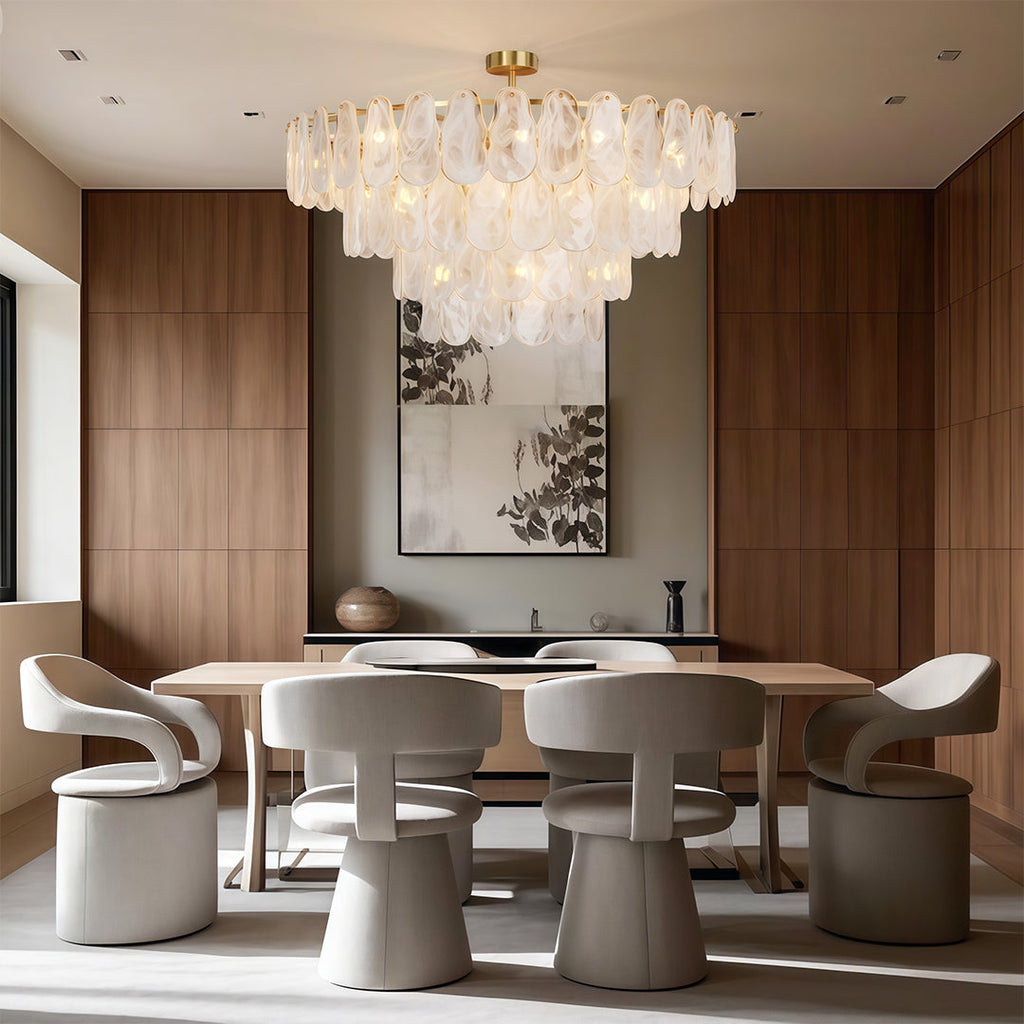 Midcentury modern chandelier illuminating elegant bedroom with upholstered bed and table lamps