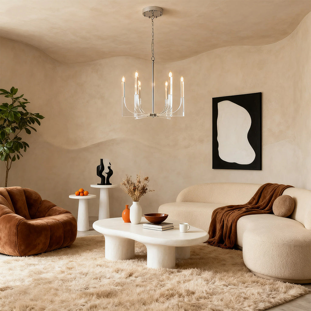 Minimalist retro chandeliers providing subtle light in a warm-toned living room with a textured rug and curved seating arrangement.