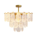 Modern luxury chandeliers featuring polished brass with layered translucent glass disc design