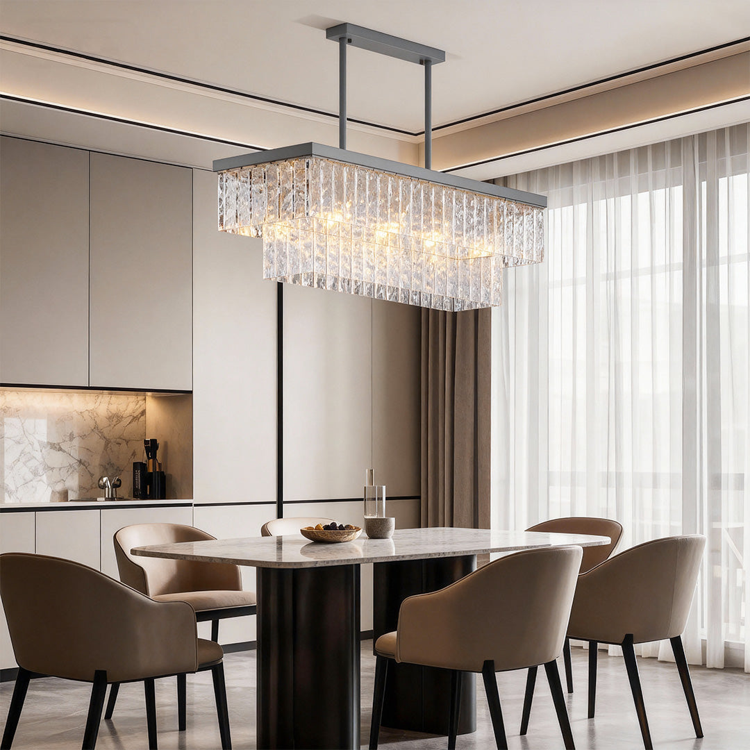 Round modern chandelier illuminating contemporary dining room with dark chairs and neutral palette