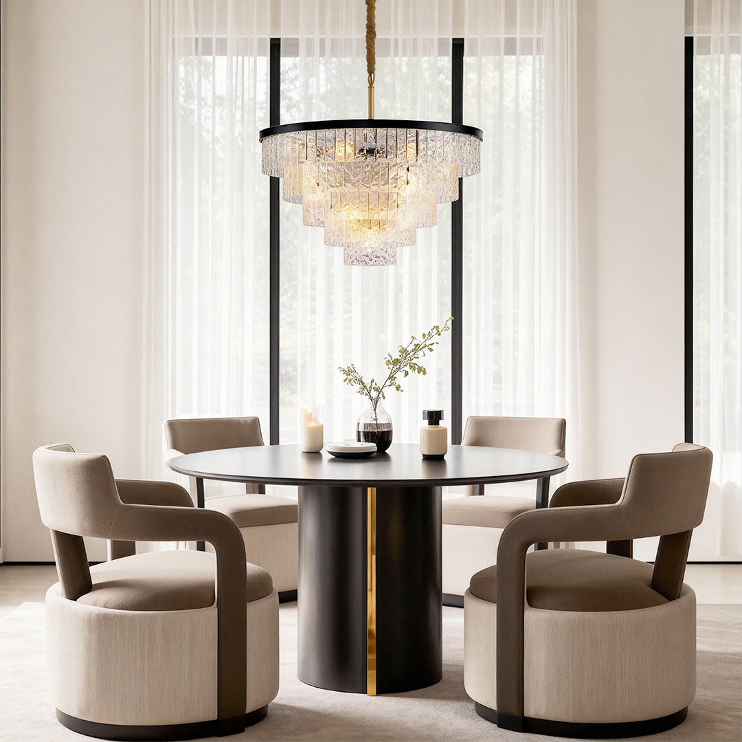 Round modern chandelier creating elegant focal point in contemporary dining space with velvet chairs