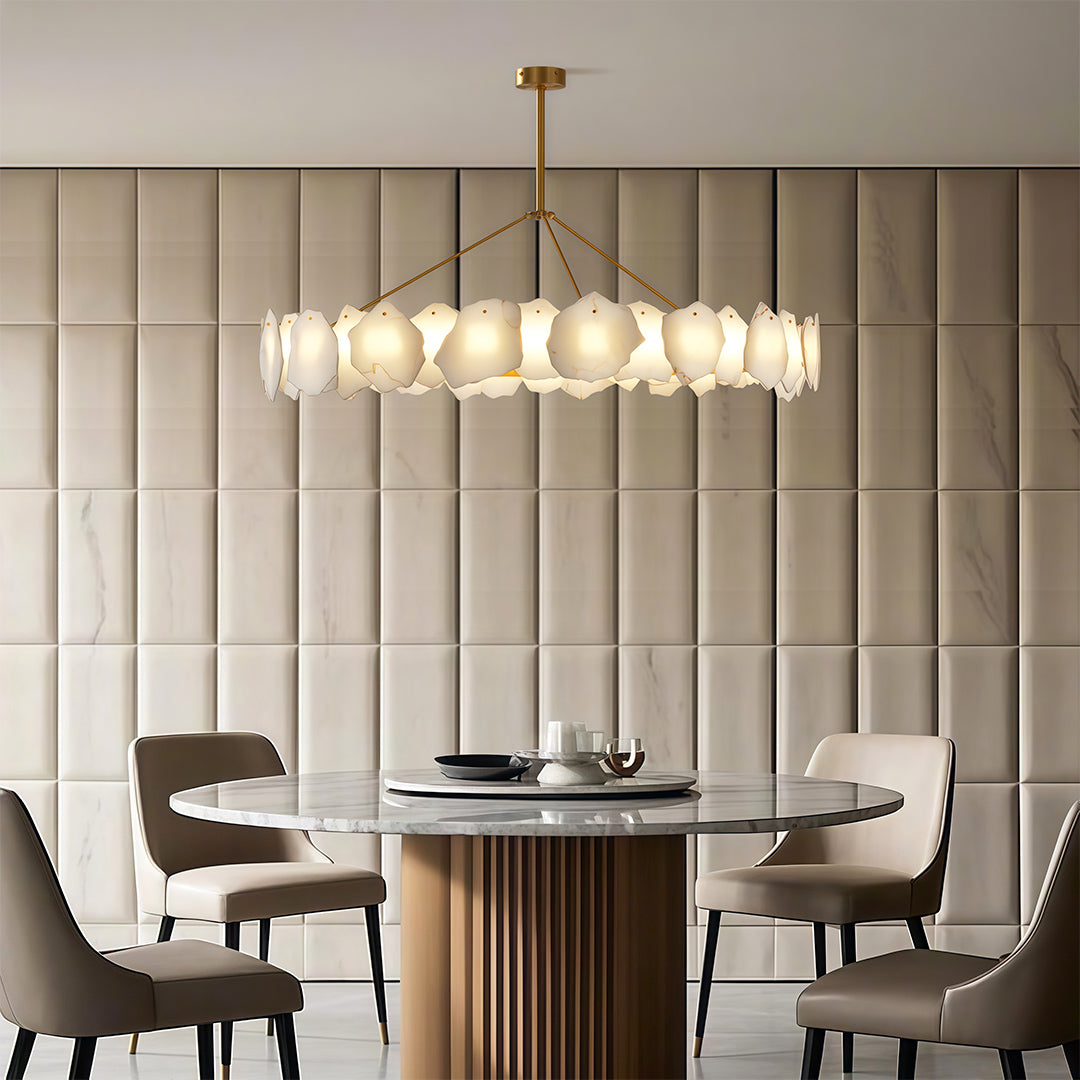 Wall art light fixtures illuminating sophisticated dining space with grey upholstered chairs